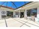 Wide outdoor patio area featuring seating, ideal for entertaining or enjoying the tranquil backyard views at 7102 42Nd E Ct, Sarasota, FL 34243