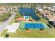 A beautiful aerial view of the community tennis court and pool near the lake at 7102 42Nd E Ct, Sarasota, FL 34243