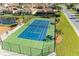 Aerial view of a pristine tennis court with well-maintained surface and surrounding landscaping at 7102 42Nd E Ct, Sarasota, FL 34243