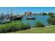 Beautiful water view showcasing boats docked in a marina, with city buildings visible in the background, framed by green foliage at 7102 42Nd E Ct, Sarasota, FL 34243