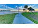 Tranquil waterfront park featuring a paved pathway, lush greenery, and stunning water views at 7102 42Nd E Ct, Sarasota, FL 34243