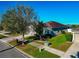 Aerial view of a single-story home with lush landscaping and neighborhood street at 718 Tanana Fall Dr, Ruskin, FL 33570