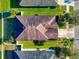 Aerial view of a well-maintained roof, green lawn, and manicured landscaping highlighting the house's curb appeal at 718 Tanana Fall Dr, Ruskin, FL 33570