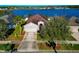 Aerial shot of single-story home near a lake and other homes, highlighting the community at 718 Tanana Fall Dr, Ruskin, FL 33570