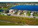 Aerial view of lakeside homes showcases lush landscaping and stunning waterfront property with a community lake at 718 Tanana Fall Dr, Ruskin, FL 33570