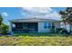 Well-maintained backyard featuring a screened lanai and lush green grass at 718 Tanana Fall Dr, Ruskin, FL 33570