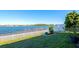 Lush backyard featuring a white picket fence with views of a tranquil lake at 718 Tanana Fall Dr, Ruskin, FL 33570