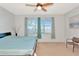 Bedroom with neutral walls, ceiling fan, a window and two chairs in the corner at 718 Tanana Fall Dr, Ruskin, FL 33570