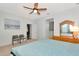 Bedroom with light walls, ceiling fan, dresser and two chairs near a doorway at 718 Tanana Fall Dr, Ruskin, FL 33570