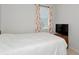 Bright bedroom featuring a large bed, neutral walls, and a window with floral print curtains at 718 Tanana Fall Dr, Ruskin, FL 33570