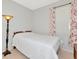 Simple bedroom with lamp, and a window at 718 Tanana Fall Dr, Ruskin, FL 33570