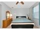 Bedroom with ceiling fan, light walls, and a dresser with a mirror at 718 Tanana Fall Dr, Ruskin, FL 33570