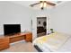 Bedroom with a desk and view into the living room at 718 Tanana Fall Dr, Ruskin, FL 33570