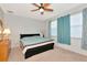 Bedroom with neutral walls, a ceiling fan, and a window with patterned curtains at 718 Tanana Fall Dr, Ruskin, FL 33570