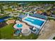 Aerial view featuring a large community pool, playground, and clubhouse area at 718 Tanana Fall Dr, Ruskin, FL 33570