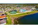 Aerial view showcasing the community pool, playground, and surrounding residential area at 718 Tanana Fall Dr, Ruskin, FL 33570