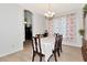 Dining room with wood table and chairs and decorative archway to the kitchen at 718 Tanana Fall Dr, Ruskin, FL 33570