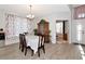 Dining room features table and chairs, floral curtains, and a cabinet at 718 Tanana Fall Dr, Ruskin, FL 33570