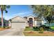 Charming single-story home featuring a two-car garage and well-maintained landscaping at 718 Tanana Fall Dr, Ruskin, FL 33570