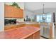 Bright kitchen with wooden cabinets, stainless steel appliances, and a large central island at 718 Tanana Fall Dr, Ruskin, FL 33570