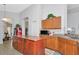 Traditional kitchen with wood cabinets, central island, and vintage Coca-Cola fridge at 718 Tanana Fall Dr, Ruskin, FL 33570