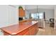 Spacious kitchen with wooden cabinetry, an island, and modern stainless steel appliances at 718 Tanana Fall Dr, Ruskin, FL 33570
