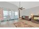 Cozy living room with sliding glass doors, neutral flooring, and a ceiling fan at 718 Tanana Fall Dr, Ruskin, FL 33570