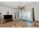 Bright living room with large sliding glass doors and neutral toned flooring at 718 Tanana Fall Dr, Ruskin, FL 33570