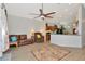 Open-concept living room featuring a large fan, rug, and access to the kitchen at 718 Tanana Fall Dr, Ruskin, FL 33570