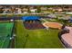 Aerial view of the playground, swing set, and tennis court in a Gathering-friendly community at 718 Tanana Fall Dr, Ruskin, FL 33570
