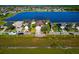 Street view of a residential property with a well-maintained lawn, palm trees, and lake view, showcasing the neighborhood at 718 Tanana Fall Dr, Ruskin, FL 33570