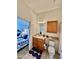 Bright bathroom featuring a single vanity, toilet, and view to bedroom space at 8397 38Th Street E Cir # 306, Sarasota, FL 34243