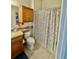 Clean bathroom featuring a shower with a curtain, toilet, and vanity with decor at 8397 38Th Street E Cir # 306, Sarasota, FL 34243
