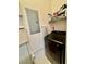 Laundry room with modern washer and dryer, featuring storage shelves for convenience at 8397 38Th Street E Cir # 306, Sarasota, FL 34243