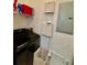 Laundry room with a modern washer, dryer, and storage shelves at 8397 38Th Street E Cir # 306, Sarasota, FL 34243