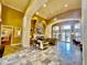 Spacious lobby with stone fireplace, comfortable seating, and elegant tile flooring at 8397 38Th Street E Cir # 306, Sarasota, FL 34243