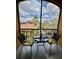 Cozy patio with a table set for two, perfect for enjoying a relaxing evening with a view at 8397 38Th Street E Cir # 306, Sarasota, FL 34243