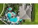 Aerial view showcasing resort-style pool, hot tub, umbrellas, lounge chairs and tropical landscaping at 9902 Craftsman Park Way, Palmetto, FL 34221