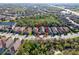 Overhead shot of a suburban neighborhood, with lush green trees in between homes with tile roofs at 9902 Craftsman Park Way, Palmetto, FL 34221
