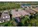 Aerial view of the property featuring a screen-enclosed pool, manicured lawn, and surrounding neighborhood at 9902 Craftsman Park Way, Palmetto, FL 34221
