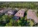 Beautiful aerial view of the property with a screened pool, lush greenery, and well-maintained landscape at 9902 Craftsman Park Way, Palmetto, FL 34221