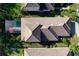 Aerial of a home with a screened-in pool and covered lanai, surrounded by lush landscaping at 9902 Craftsman Park Way, Palmetto, FL 34221
