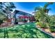 Beautiful backyard featuring a screened-in pool, manicured lawn, and lush landscaping at 9902 Craftsman Park Way, Palmetto, FL 34221