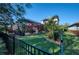 Spacious backyard with manicured lawn, screened-in pool, and beautiful landscaping at 9902 Craftsman Park Way, Palmetto, FL 34221