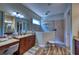Luxurious bathroom with dual vanities, walk-in shower, and elegant finishes at 9902 Craftsman Park Way, Palmetto, FL 34221