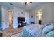 Inviting bedroom featuring wood-look floors, ceiling fan, a large tv and relaxing decor at 9902 Craftsman Park Way, Palmetto, FL 34221