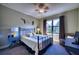 Comfortable bedroom with a large window, ceiling fan, and a full bed with stylish decor at 9902 Craftsman Park Way, Palmetto, FL 34221