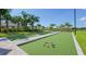 Outdoor bocce ball court surrounded by lush landscaping and palm trees at 9902 Craftsman Park Way, Palmetto, FL 34221