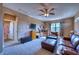 Bonus room featuring leather seating, TV, ceiling fan and bright natural light at 9902 Craftsman Park Way, Palmetto, FL 34221