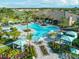 Aerial view of the community pool area featuring a huge pool, seating and lounging areas, and lush landscaping at 9902 Craftsman Park Way, Palmetto, FL 34221